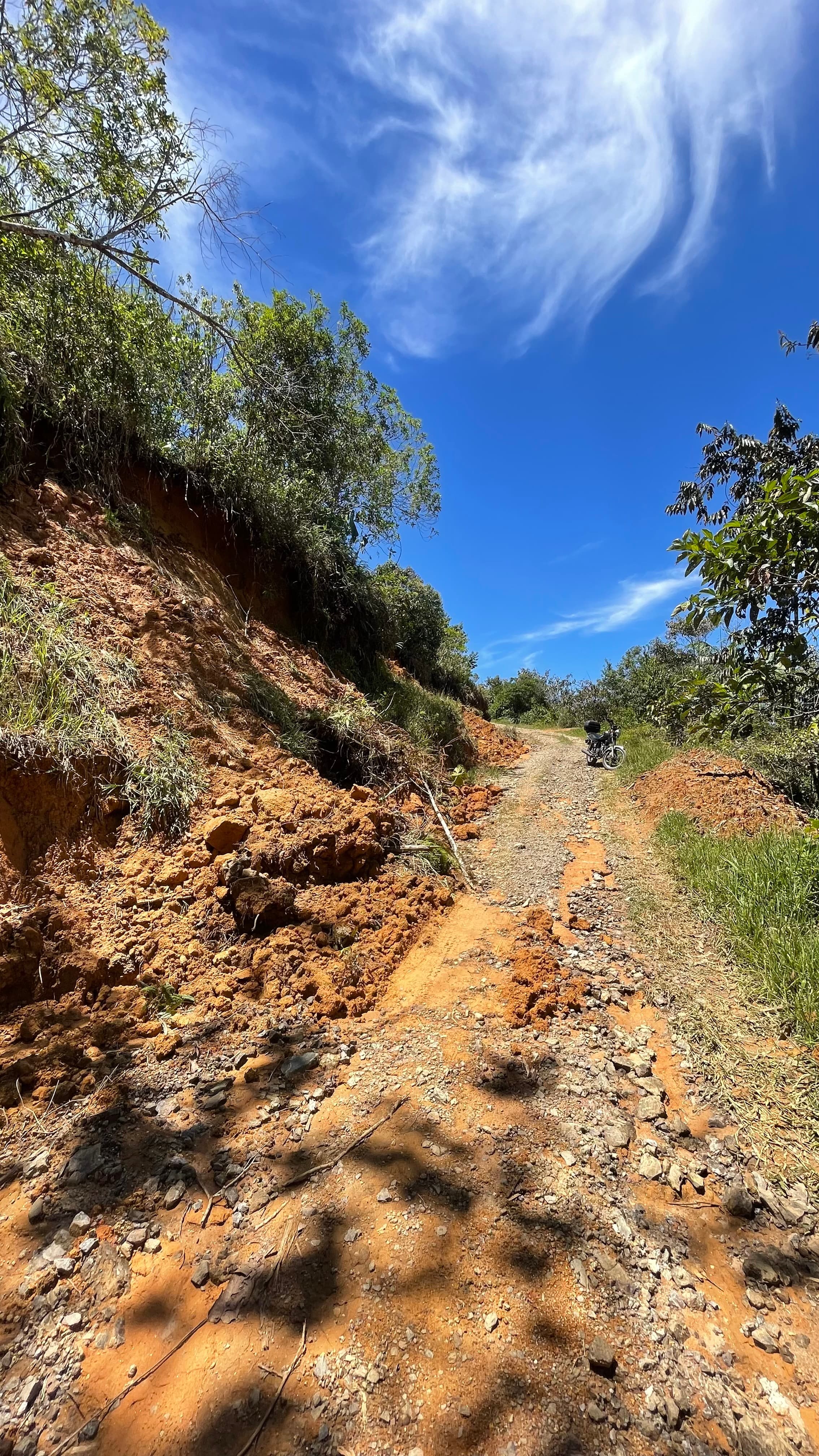 Eroded hillside beside a rural road in San Rafael before stabilization work.